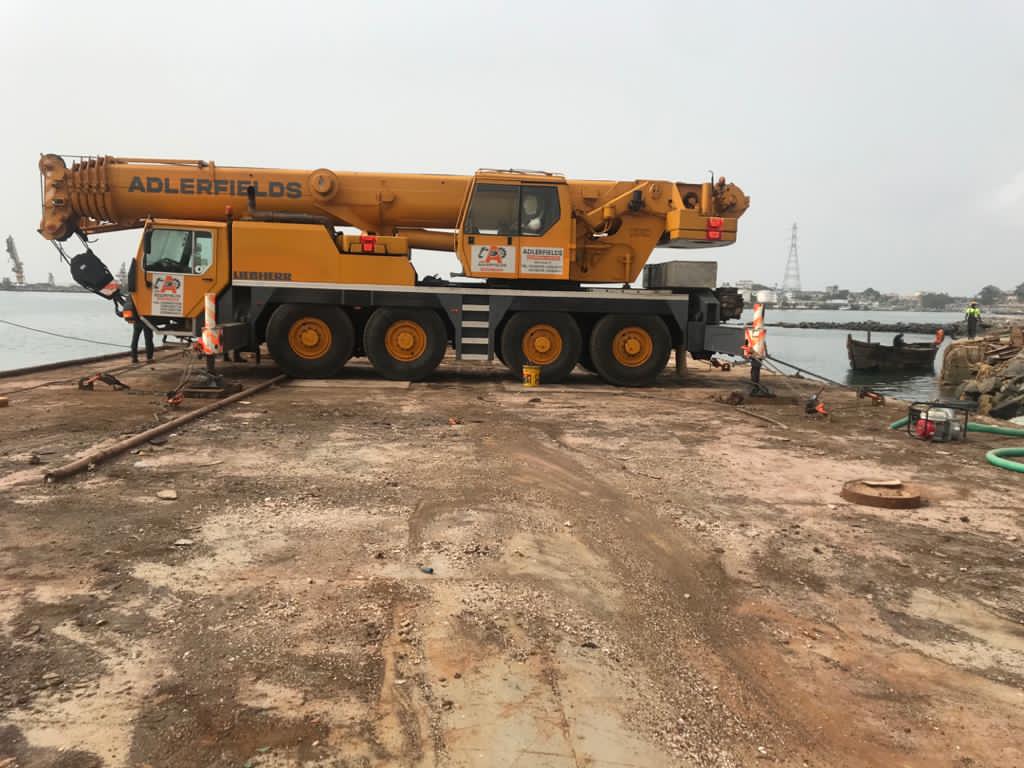 Yellow Adlerfields all-terrain mobile crane at a port