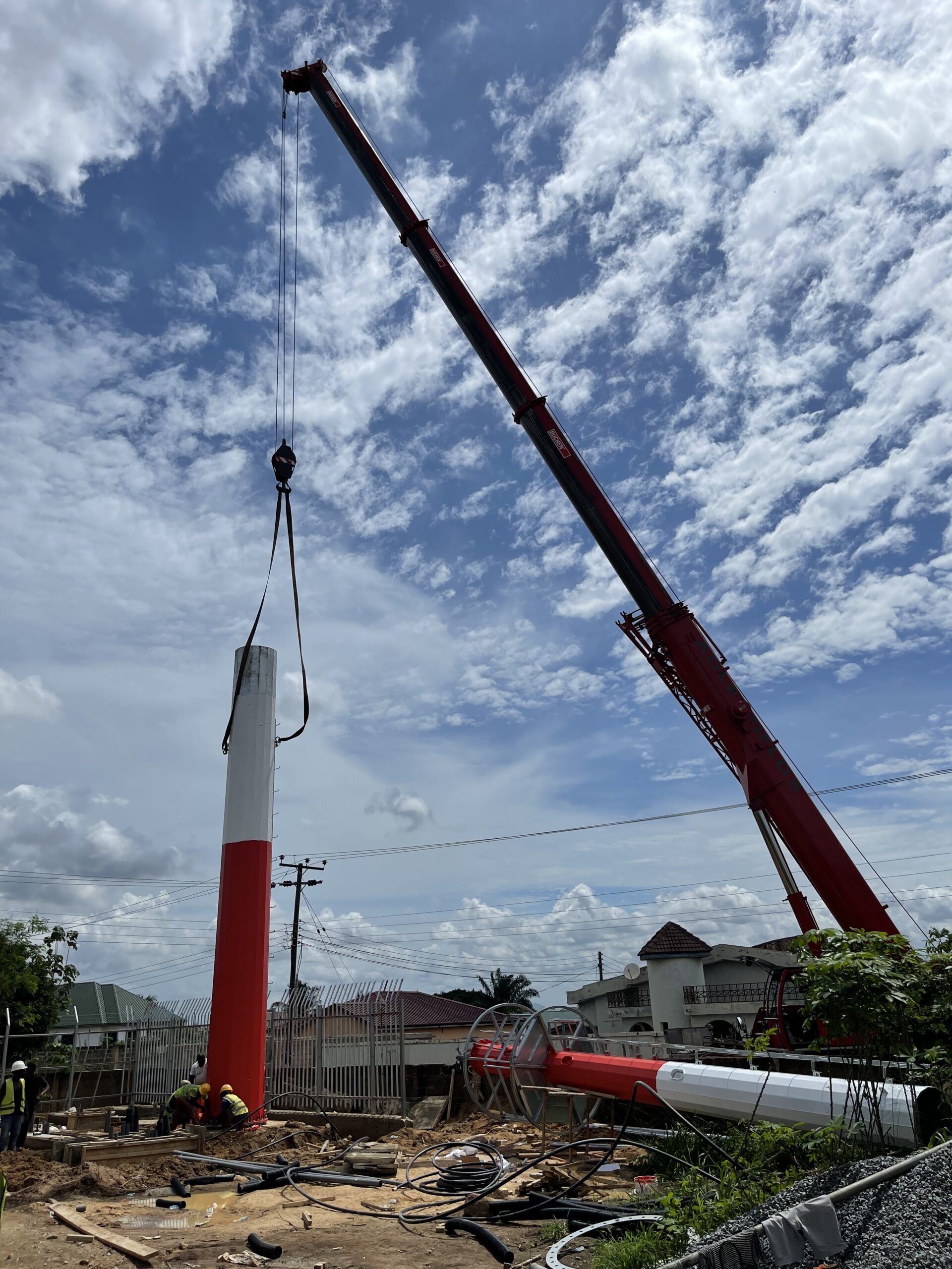 Crane installing an MTN telecommunications monopole
